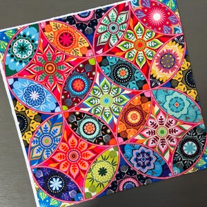 May include: A colorful fabric with a repeating pattern of circular designs. The fabric features a variety of colors, including red, blue, green, yellow, and orange. The circular designs are intricate and detailed, and they are arranged in a symmetrical pattern.
