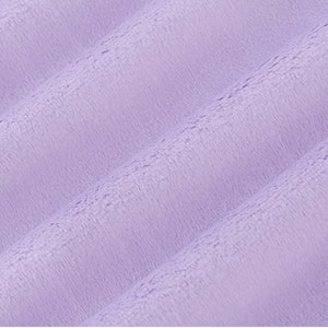 May include: A close-up of a soft, plush fabric in a light purple color. The fabric has a subtle texture and a slightly fuzzy appearance.