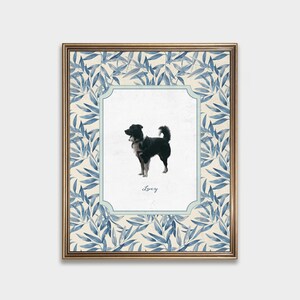May include: A framed print of a black and white dog with a blue and white floral border. The dog is standing and looking to the right. The print has the name "Lucy" written below the dog.
