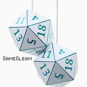 May include: Two white twenty-sided dice hanging from thin silver chains. Each die features numbers printed in a blue-to-green gradient. The text GAMEGLEAM is printed in black pixelated font to the left of the lower die against a white background.