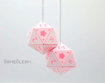 May include: Two pink and white 12-sided dice with numbers 1 through 12 and a pink star design hanging from silver chains.