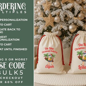 May include: Two off-white drawstring Christmas gift bags with red drawstrings. Each bag features a colorful graphic of Santa Claus with a surfboard and the text "Da Kine Christmas Delivery". One bag is personalized with the name "Elijah", the other with "Leilani".