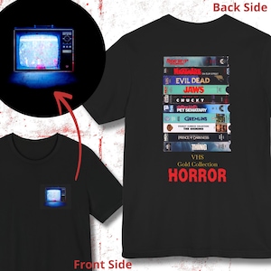 May include: Black t-shirt with a graphic of a stack of VHS tapes featuring classic horror movies. The text "VHS Gold Collection HORROR" is printed below the tapes.