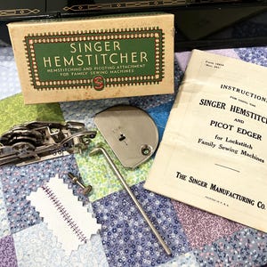 May include: A vintage Singer hemstitcher and picot edger attachment set for sewing machines. Includes a tan cardboard box with green text, a metal hemstitcher mechanism, a throat plate, a small screw, a metal rod, and an instruction manual.