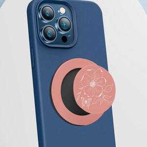 Rose Butterfly Collapsable Grip and Stand in Black on blue phone.