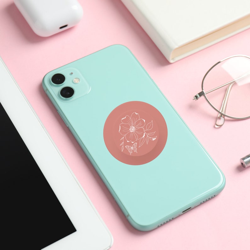 Rose Butterfly Collapsable Grip and Stand on mint green phone.