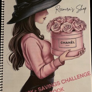 May include: A woman wearing a black hat and pink sweater holds a pink box with a bouquet of pink roses. The box has the word "CHANEL" printed on it. The text "Reemira's Shop" is written in cursive at the top of the image. The text "$150K+ SAVINGS CHALLENGE BOOK" is written in black at the bottom of the image.