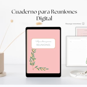 May include: A digital meeting notebook with a pink cover featuring the text "Apuntes para REUNIONES" and a floral design. Additional pages with lined paper and a contents page are also visible. The notebook is displayed on a white surface.