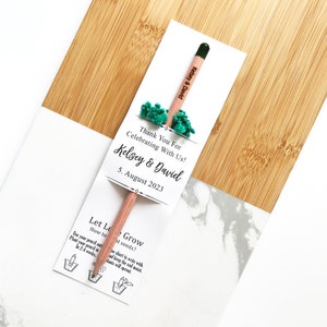 There are colorful flowers and a pencil with seeds on the card.