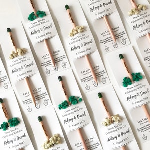 There are colorful flowers and a pencil with seeds on the card.