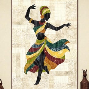 May include: A framed artwork depicts a silhouette of a dancing figure in colorful attire. The figure is adorned in a patterned dress with green, yellow, and red accents. The background features a neutral, textured pattern, and the artwork is framed in a brown border.