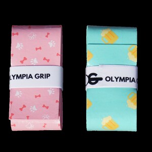 May include: Four rolls of Olympia Grip tape in various patterns. One roll is white with watermelon and lemon slices. Another is pink with paw prints and bones. A third is teal with beer mugs, and the last is blue with dolphins.