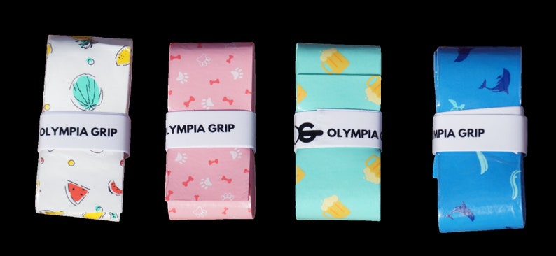 May include: Four rolls of Olympia Grip tape in various patterns. One roll is white with watermelon and lemon slices. Another is pink with paw prints and bones. A third is teal with beer mugs, and the last is blue with dolphins.