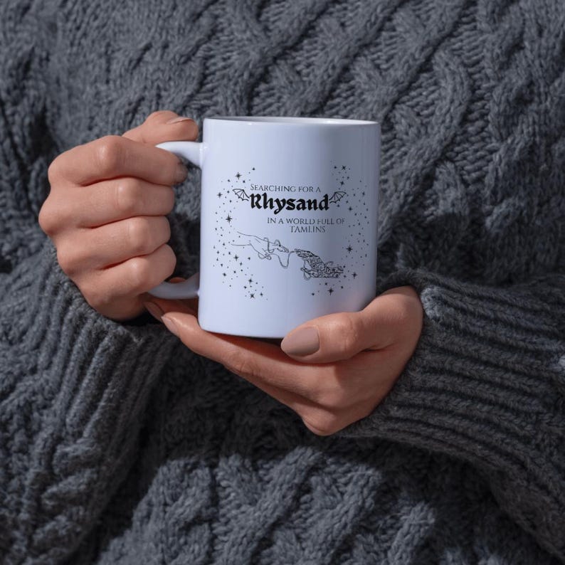 May include: White ceramic mug with a black design that reads "Searching for a Rhysand in a world full of Tamlins".