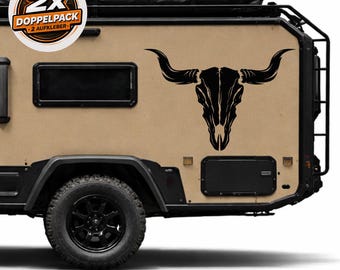 May include: A black steer skull decal is affixed to the side of a tan camper. The camper has black wheels and trim. A sticker on the top left corner reads "2x DOPPELPACK 2 AUFKLEBER".