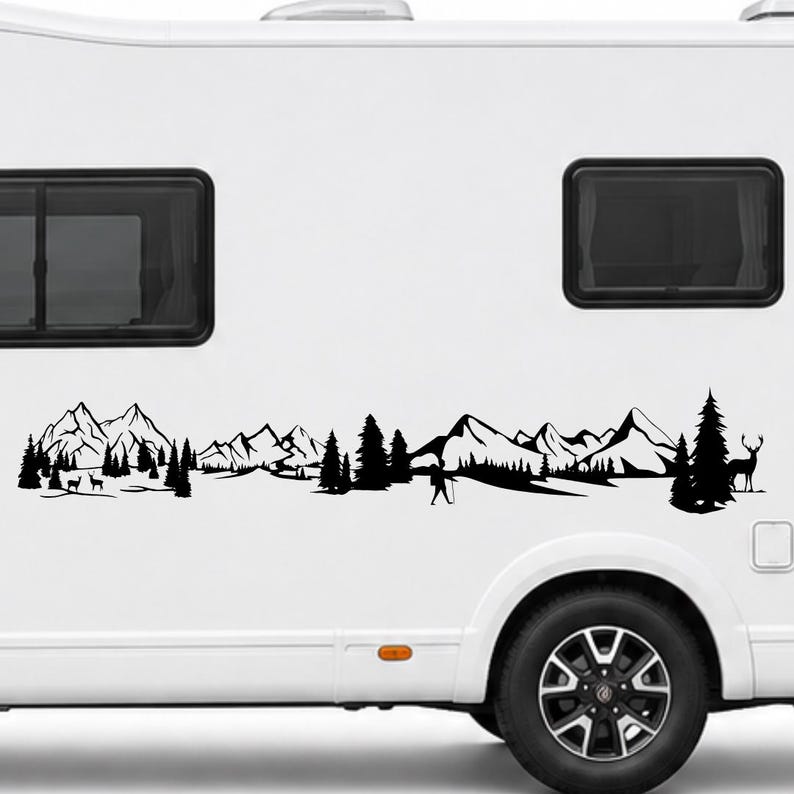 May include: A black vinyl decal applied to the side of a white recreational vehicle. The design features a continuous landscape silhouette including jagged mountain peaks, dense pine forests, a lone hiker with a walking stick, and two deer.