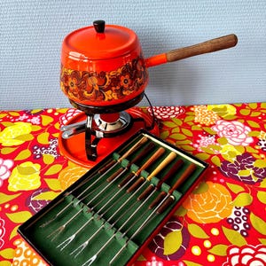 Vintage fondue set with orange enamel forks and flowers from 1970