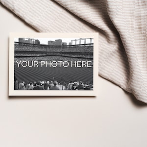 May include: A black and white photograph of a baseball stadium with the text "YOUR PHOTO HERE" printed on the image. The photograph is in a cream-colored frame, with a beige and white striped fabric in the background.