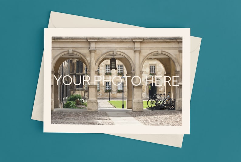 May include: A cream-colored card with the text "YOUR PHOTO HERE" overlaid on a photograph of an arched stone walkway. The card is on top of a cream-colored envelope, set against a teal background.