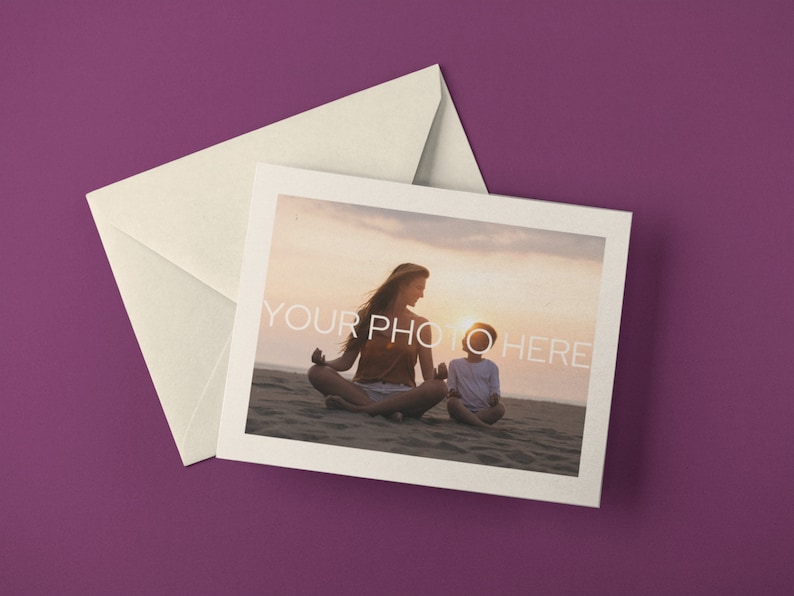May include: A cream-colored envelope and a greeting card with a photograph of a person and child meditating on a beach at sunset. The card has a white border and the text "YOUR PHOTO HERE". The background is a solid purple.