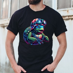 May include: A black t-shirt with a colorful graphic of a turtle wearing a helmet with an American flag design and goggles. The turtle is holding a gun and has a determined expression.