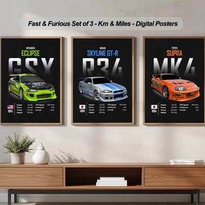 Puede incluir: Tres carteles digitales enmarcados con coches de la franquicia Fast & Furious. Los carteles muestran un Eclipse, Skyline GT-R y Supra, cada uno en colores vibrantes. Los carteles incluyen especificaciones de los coches y se muestran sobre un mueble de madera.