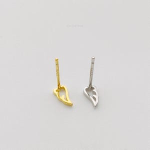 May include: Two pairs of earrings, one gold and one silver, in the shape of a wing. Both earrings have a post back.