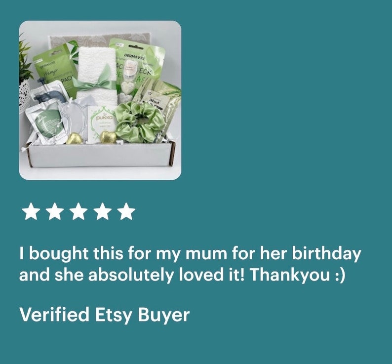 May include: A white gift box filled with green and white bath and body products. The box includes a white towel, a green headband, a green bath bomb, and a green face mask. The box is labeled "Mud".