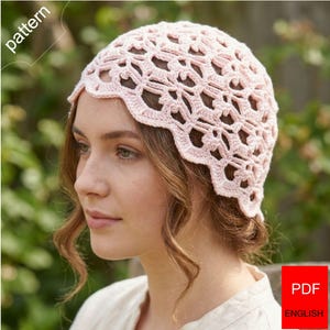 May include: A light pink crochet hat featuring an intricate openwork lace pattern with a scalloped edge. The image includes the text "pattern" in the upper left corner and a red box with the text "PDF ENGLISH" in the lower right corner.
