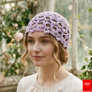 May include: A light purple crochet beanie featuring an intricate openwork pattern with a scalloped edge. The headwear is crafted from yarn and sits snugly on the head, showcasing a detailed, repeating geometric design throughout the fabric.