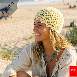 May include: A light yellow crocheted hat with a scalloped edge. The hat has an open, lacy design. The image also shows a woman wearing a turquoise necklace and a cream-colored blouse. The word "pattern" is visible in the upper left corner.