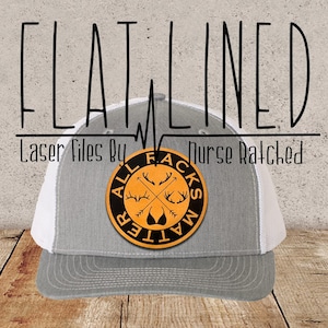 May include: A grey and white trucker hat with a black and orange patch that says "All Facts Matter" with a deer skull and antlers design. The text "Flatlined" is written above the hat.