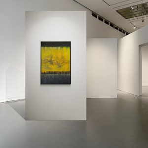 May include: A framed abstract painting with yellow, black, and blue hues. The painting is hanging on a white wall in a gallery setting.