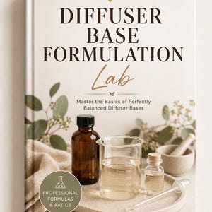 May include: A hardcover book titled Diffuser Base Formulation Lab with the subtitle Master the Basics of Perfectly Balanced Diffuser Bases. The cover features a brown glass bottle, a glass beaker, a small vial, and a mortar and pestle.