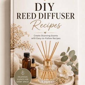 May include: A book titled DIY REED DIFFUSER Recipes with the subtitle Create Stunning Scents with Easy-to-Follow Recipes. The cover features a glass reed diffuser, amber bottles, dried flowers, and a circular badge stating DELICIOUS SCENTS FOR EVERY SPACE.
