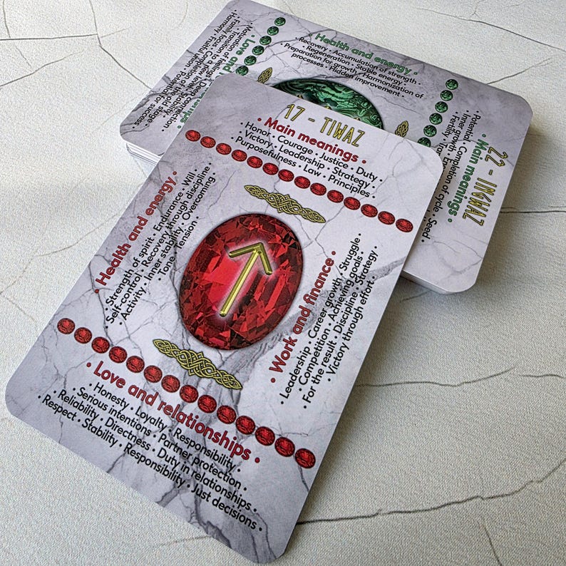 May include: A deck of oracle cards with a marble-like background. The cards feature text about health, love, and work, with a central red gemstone design. The cards are used for divination and spiritual guidance.