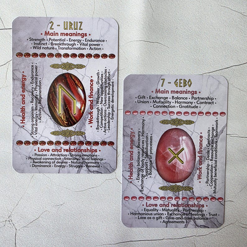 May include: Two rectangular tarot cards with text and rune symbols. One card features a red and brown stone with the rune "Uruz" and the number "2". The other card has a pink stone with the rune "Gebo" and the number "7".