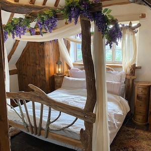 May include: A rustic bedroom with a canopy bed. The bed frame is made of natural wood, and the canopy is draped with white fabric and adorned with purple flowers. The room features wooden furniture and a soft, inviting atmosphere.