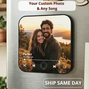 Könnte beinhalten: Ein schwarzer rechteckiger Magnet mit einem Foto eines lächelnden Paares bei Sonnenuntergang. Der Magnet enthält den Text "Your Custom Photo & Any Song" und eine Musikplayer-Oberfläche mit dem Song "Perfect" von Ed Sheeran.