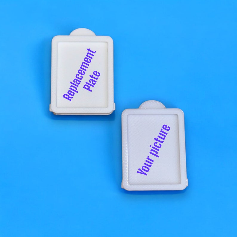May include: Two white rectangular frames with rounded corners. The top frame says "Replacement Plate" in purple text. The bottom frame says "Your picture" in purple text.