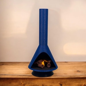May include: A blue ceramic fireplace with a triangular base and a tall chimney. The fireplace has a small opening in the front, revealing a glowing fire with logs inside.