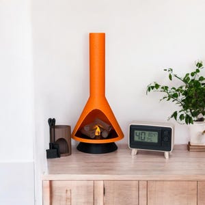 May include: An orange and black modern fireplace with a faux fire inside. The fireplace is on a wooden surface with a small white clock that reads "40 80.4%" on the right side of the image.