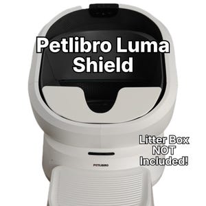 May include: A white Petlibro Luma Shield accessory with a black interior and a textured front step. The text Petlibro Luma Shield is displayed at the top, and the text Litter Box NOT Included! is visible on the right side of the white unit.