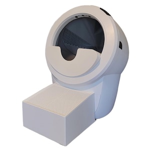 May include: A white, automated cat litter box with a rounded main compartment and a rectangular step. The litter box has a circular opening and a dark interior. The step has a perforated surface.