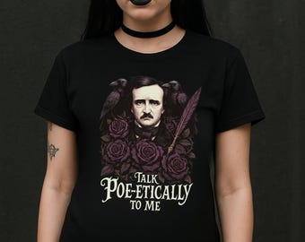 May include: Black t-shirt with a graphic of Edgar Allan Poe, purple roses, and ravens. The text "Talk Poe-etically to Me" is displayed in a stylized font, creating a gothic and literary theme.
