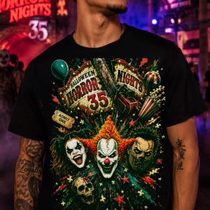 May include: A black t-shirt featuring a graphic print with the text Halloween Horror Nights 35. The design includes three clown faces, a skull, a green balloon, a chainsaw, a popcorn bucket, and an Admit One ticket against a dark background.