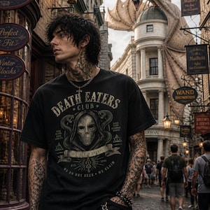 May include: Black t-shirt with the text "DEATH EATERS CLUB" and a graphic of a skull and snakes. The shirt also has the text "TOGETHER IN DARKNESS" and "WE DO NOT SEEK WE CLAIM". The background shows a street scene with buildings and signs.