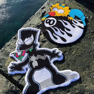 May include: Three colorful, handmade rugs featuring cartoon characters. One rug depicts Bart Simpson as Venom, another shows Maggie Simpson on an 8-ball, and the third is a Bart Simpson rug. The rugs are black, white, yellow, blue, and green.