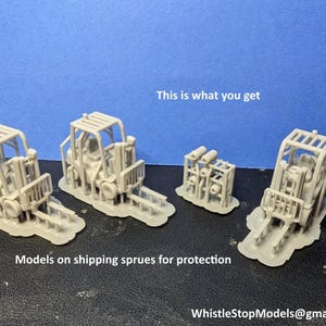 May include: Four gray plastic model forklifts on sprues, ready to be assembled.  This is what you get. Models on shipping sprues for protection. WhistleStopModels@gmail.com