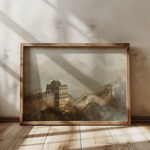 May include: A framed print of the Great Wall of China, with a misty mountain background. The wall is made of stone and has watchtowers. The print is in a wooden frame.